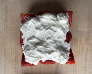 Bread topped with whipped cream after strawberries