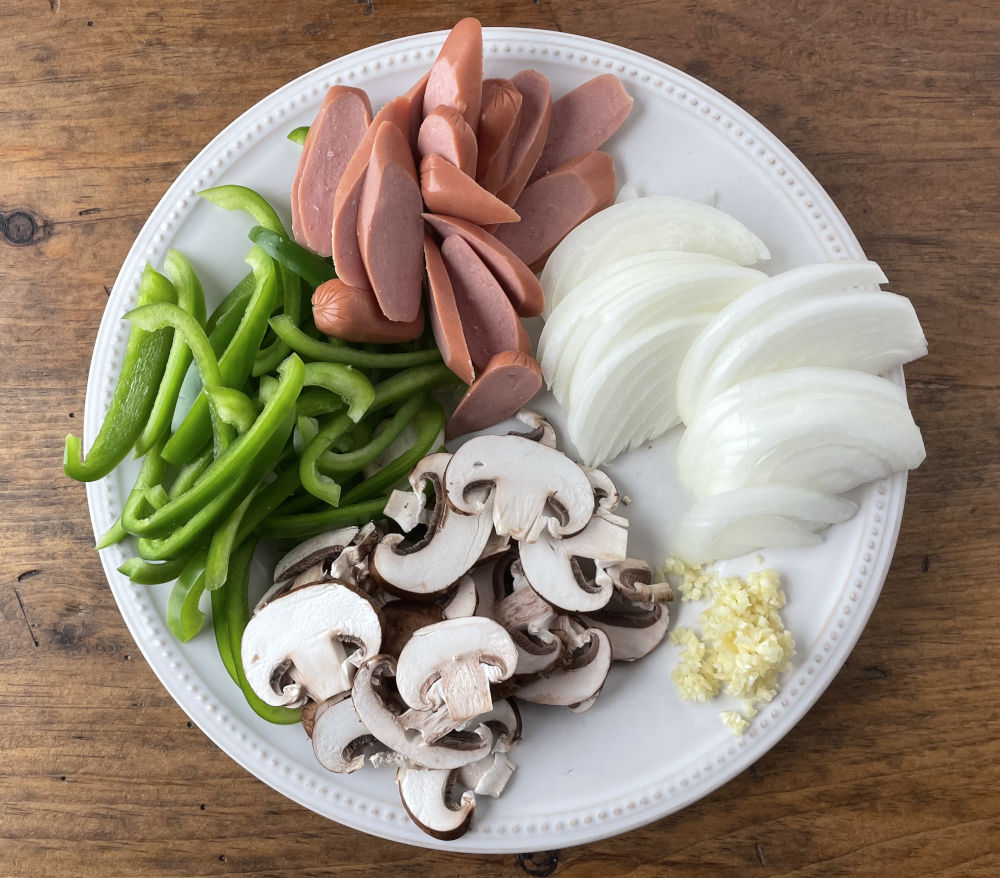 Sliced onions, bell pepper, mushrooms and hot dogs