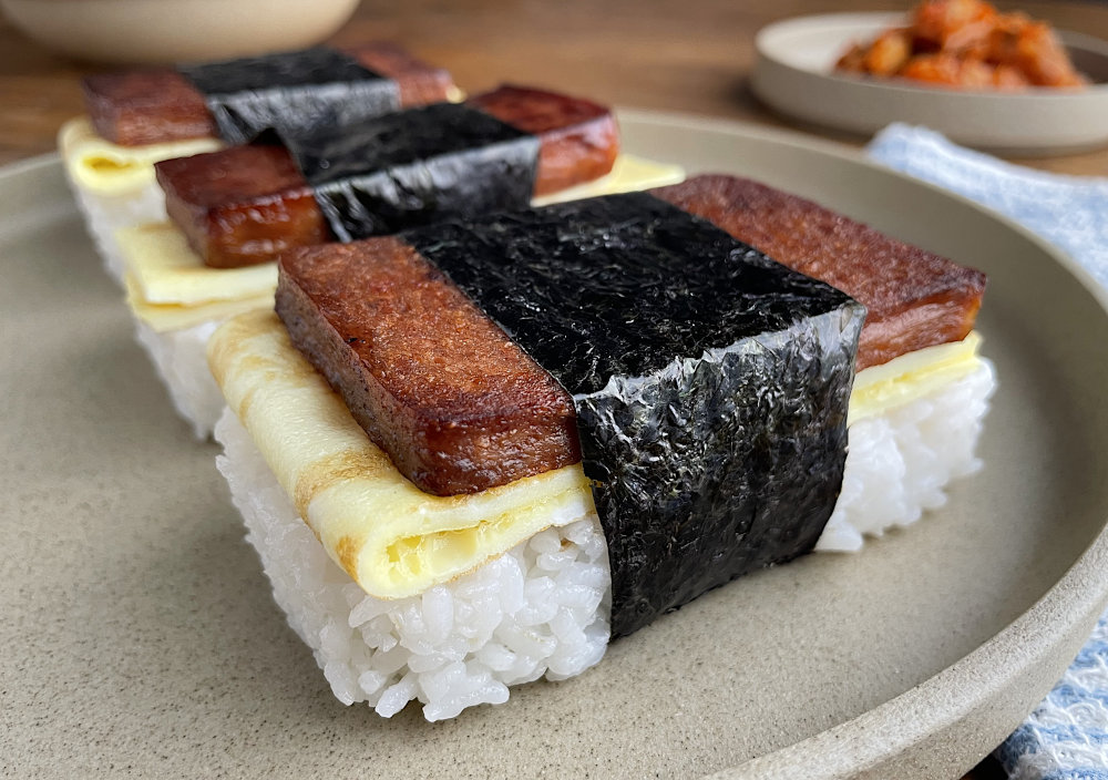 Spam musubi from the side on a tan plate