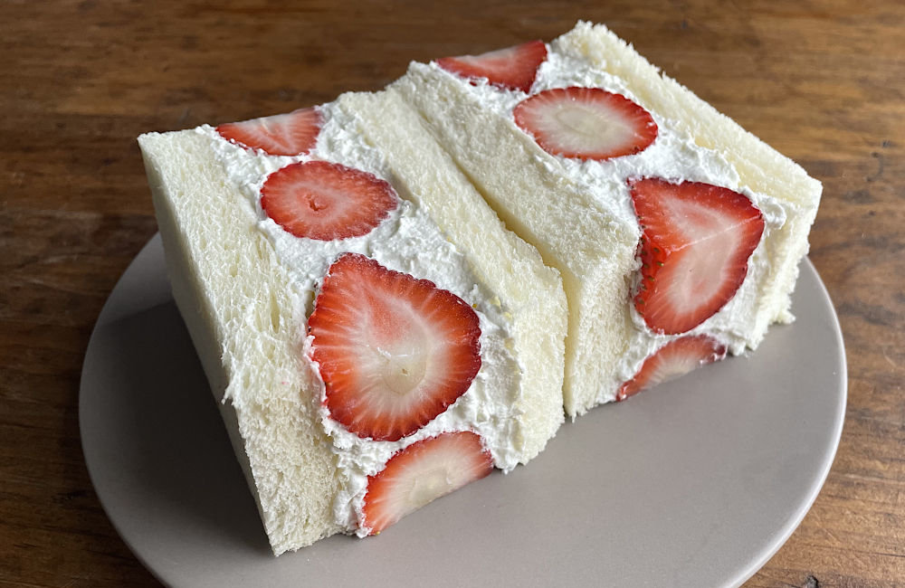 Strawberry sando on gray plate from angle