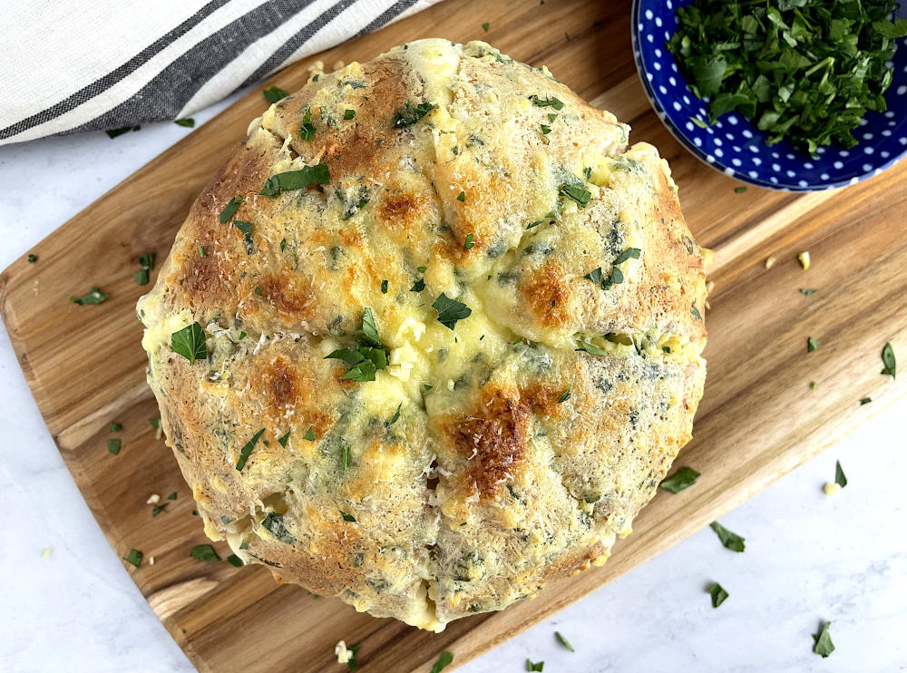 Cream cheese garlic bread with parsley on the side