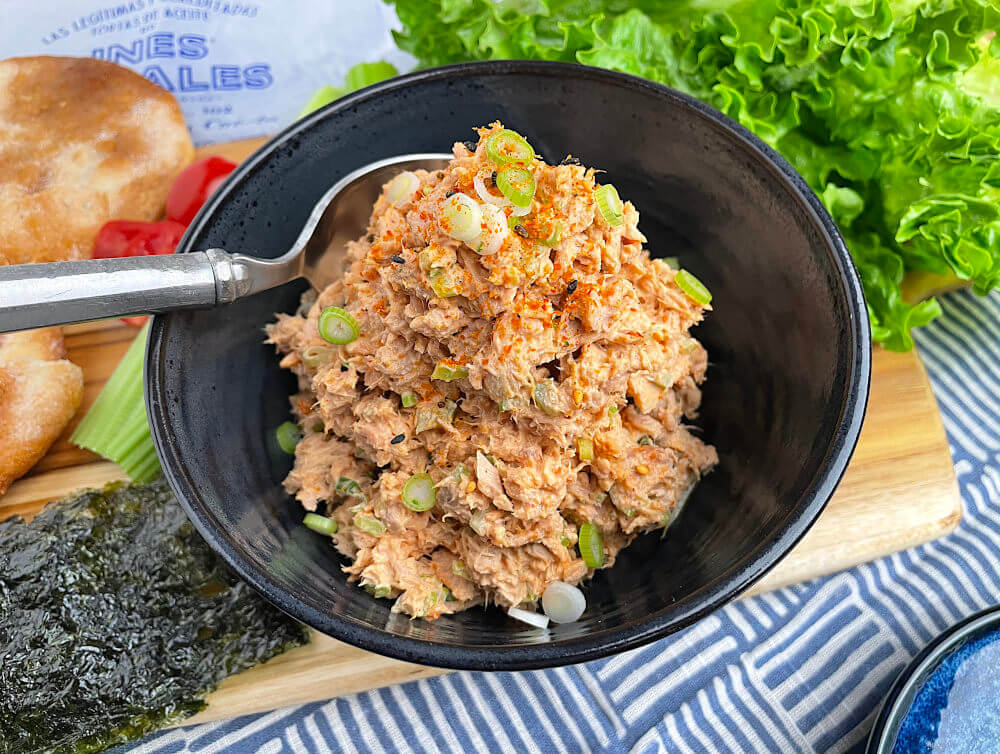 Gochujang tuna salad in a black bowl with a spoon
