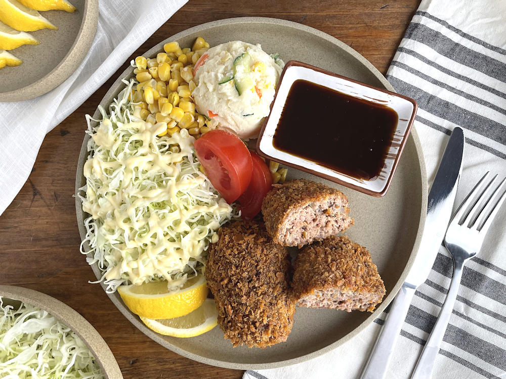 Menchi katsu on a tan plate