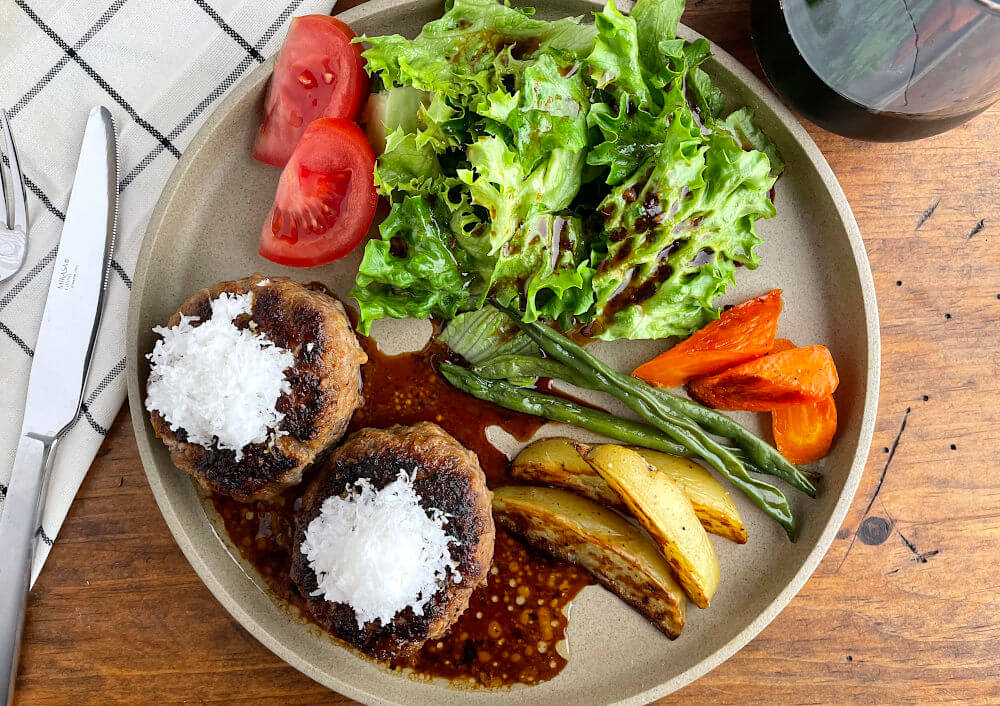 Wafu hambagu with oroshi and ponzu on a tan plate